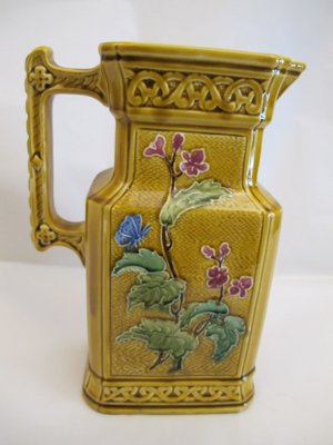 Barbotine jug with flowers and butterfly